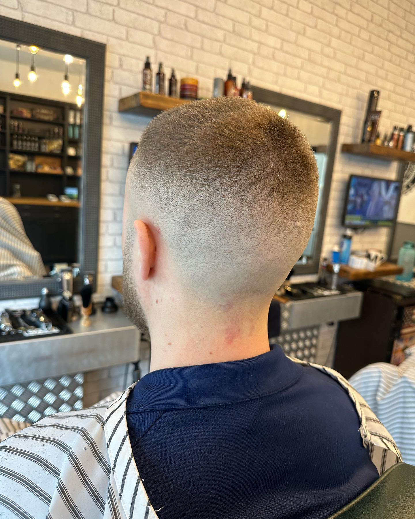 Mid skin fade with textured top styled by Kristian Brett